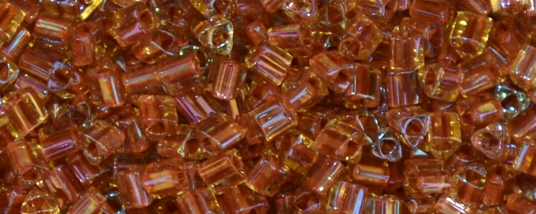 (image for) TOHO Size 11/o Triangle Shape Seed Bead-Light Brick Red Lined Topaz Transparent
