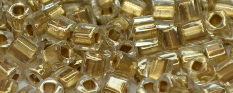 (image for) TOHO 4mm Cube Shape Seed Beads-Bronze Lined Crystal Transparent