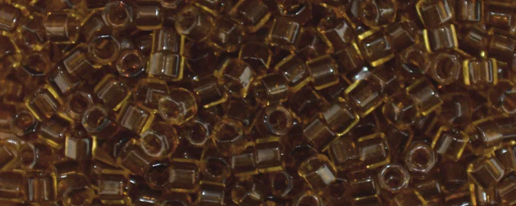 (image for) TOHO Aiko Hexagon Precision Cylinder Bead. Dark Golden Amber Transparent TBC-2152